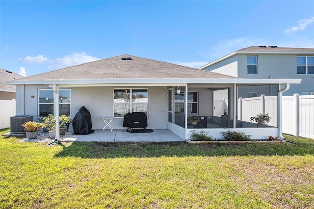 rear view of property featuring a patio area, a lawn, cooling unit, and a sunroom