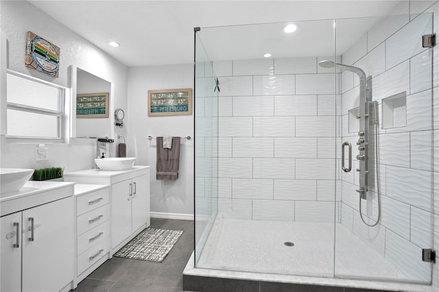 bathroom with baseboards, tile patterned floors, vanity, a shower stall, and recessed lighting