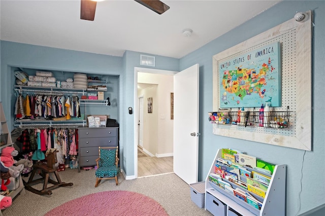 game room with carpet floors, visible vents, and ceiling fan