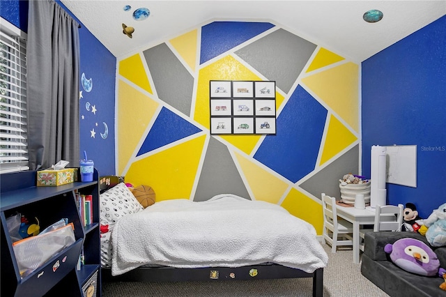 bedroom featuring vaulted ceiling and carpet flooring