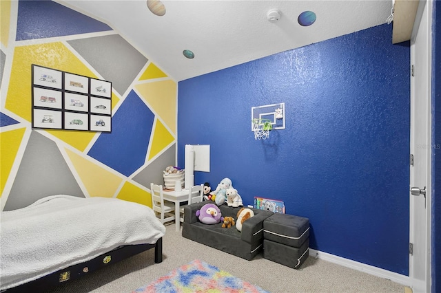 carpeted bedroom with lofted ceiling, a textured wall, and baseboards