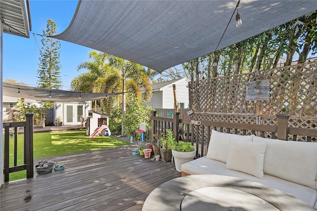 deck with an outdoor hangout area, french doors, a lawn, and fence