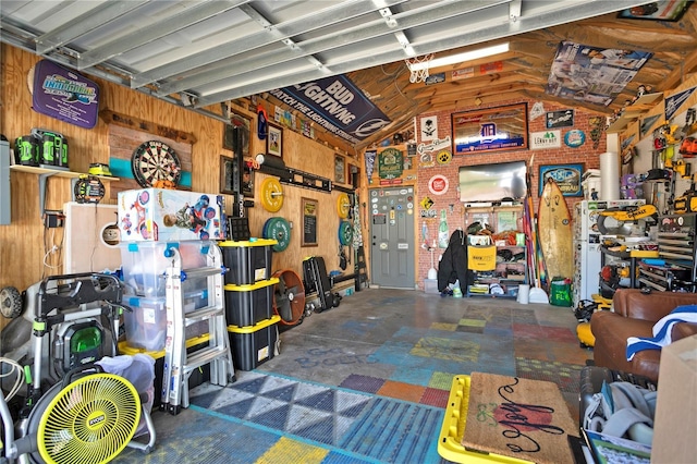 garage with wood walls and a workshop area