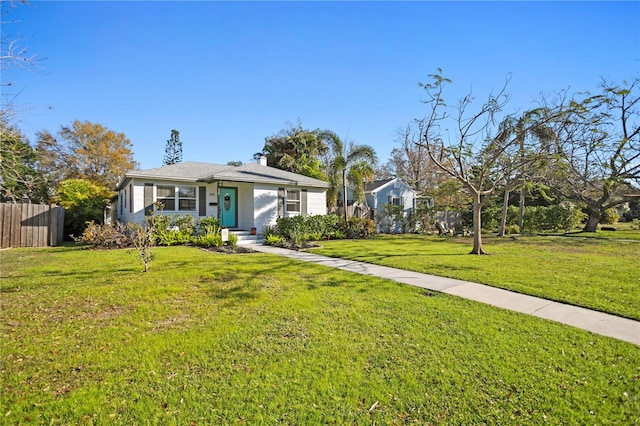 view of front facade with a front yard and fence