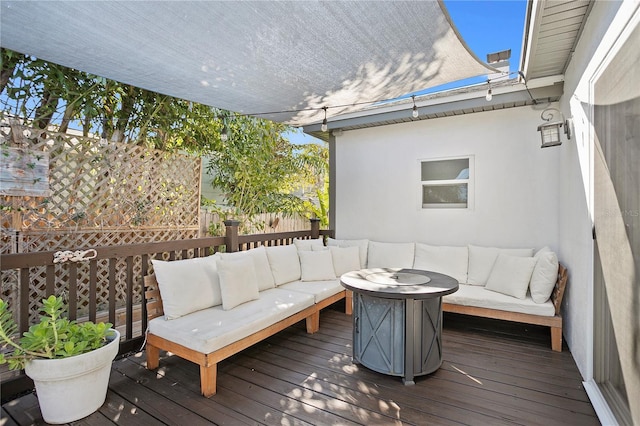 wooden terrace with an outdoor living space