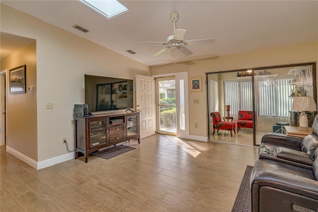 living room with a ceiling fan, light wood-type flooring, and visible vents