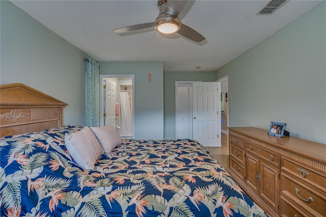 bedroom with ceiling fan, connected bathroom, and visible vents