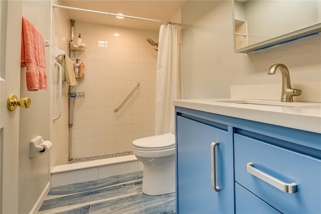 bathroom with toilet, a stall shower, and vanity