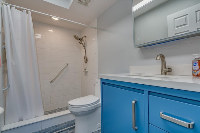 bathroom with a stall shower, visible vents, vanity, and toilet