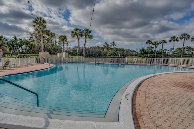 pool featuring a patio and fence