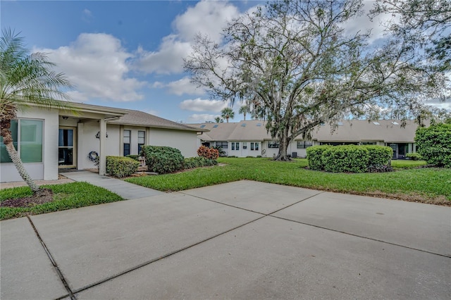 single story home with a front lawn and stucco siding