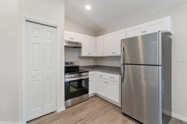 kitchen featuring dark countertops, under cabinet range hood, white cabinetry, and appliances with stainless steel finishes