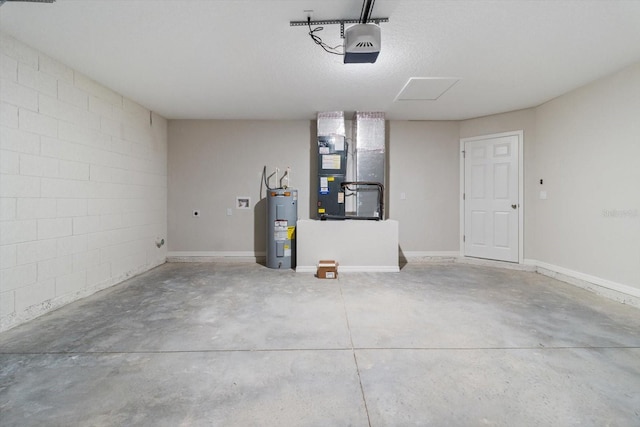 garage featuring concrete block wall, baseboards, a garage door opener, heating unit, and water heater