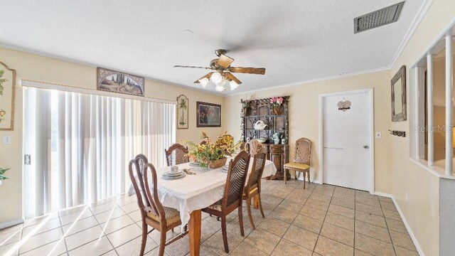 2453 Teri St, Auburndale, FL 33823 - dining space featuring crown molding, visible vents, a ceiling fan, light tile patterned flooring, and baseboards