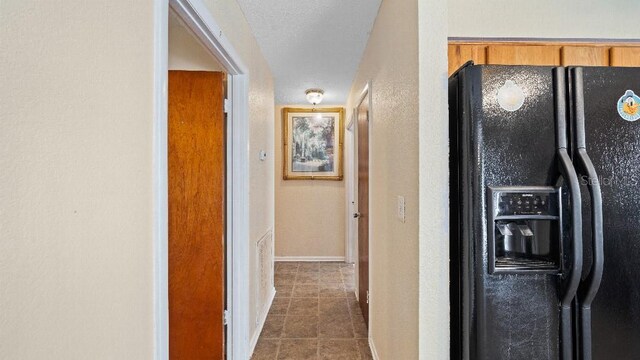 2453 Teri St, Auburndale, FL 33823 - corridor with dark tile patterned floors and baseboards