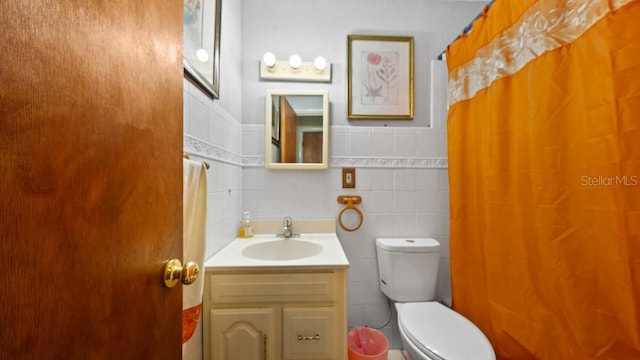 2453 Teri St, Auburndale, FL 33823 - bathroom featuring tile walls, a shower with shower curtain, vanity, and toilet