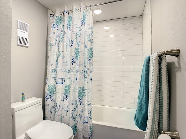 bathroom with shower / bath combo with shower curtain and toilet