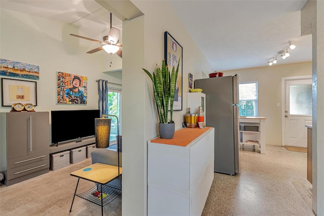 kitchen featuring light speckled floor, freestanding refrigerator, gray cabinets, and ceiling fan