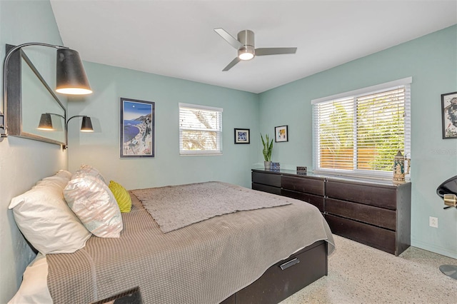 bedroom featuring speckled floor and a ceiling fan