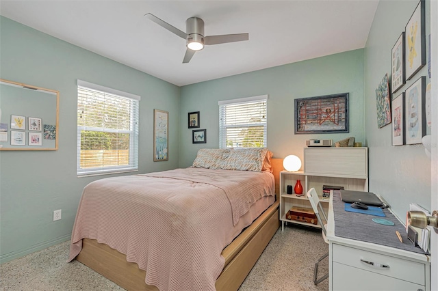 bedroom with light speckled floor and a ceiling fan