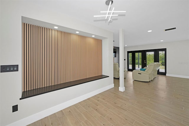 interior space with french doors, recessed lighting, wood finished floors, and baseboards