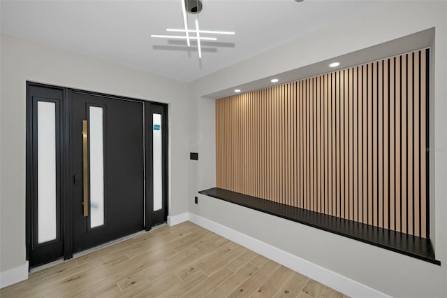 foyer entrance featuring light wood-style flooring, baseboards, and recessed lighting