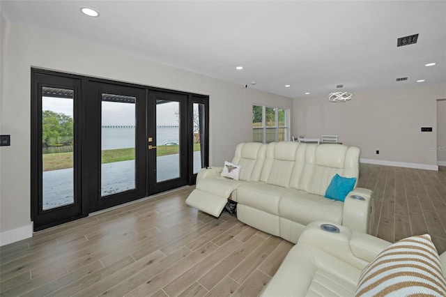 living room with french doors, recessed lighting, visible vents, light wood-type flooring, and baseboards