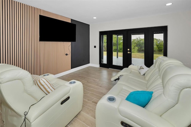 living room featuring recessed lighting, light wood-style flooring, baseboards, and french doors