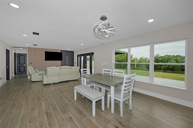 dining area with light wood finished floors, visible vents, baseboards, and recessed lighting