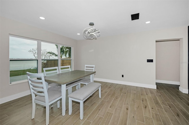 dining room featuring recessed lighting, a notable chandelier, baseboards, and wood finished floors