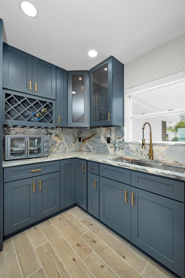 kitchen with a healthy amount of sunlight, decorative backsplash, and a sink