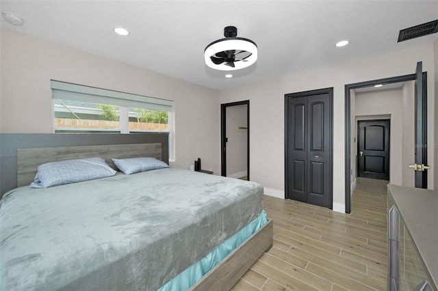 bedroom with recessed lighting, visible vents, and wood finish floors