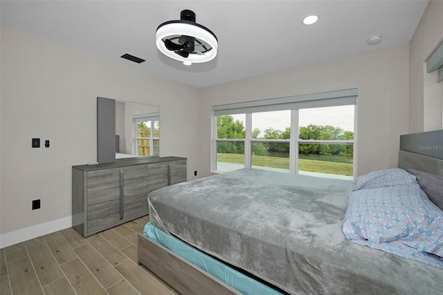 bedroom with light wood-style flooring, recessed lighting, visible vents, and baseboards