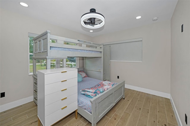 bedroom with recessed lighting, light wood-style flooring, and baseboards