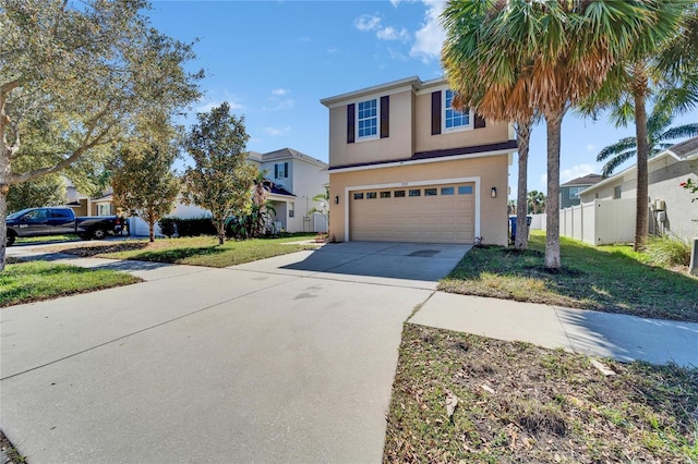 traditional home with a garage, concrete driveway, a residential view, stucco siding, and a front yard