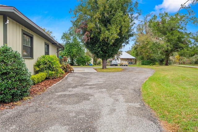 exterior space with driveway and a lawn