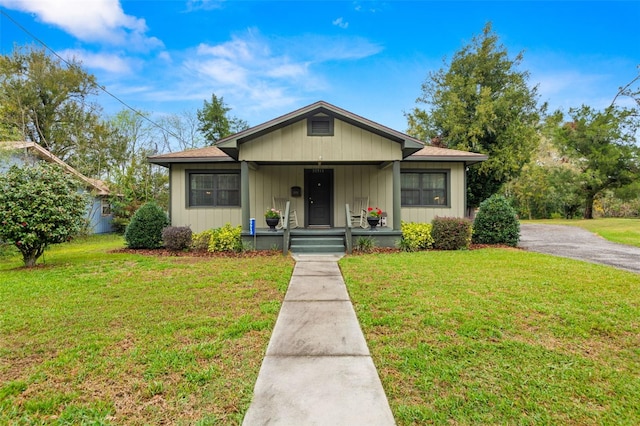 bungalow-style home with a porch and a front yard