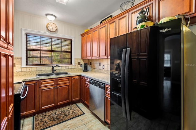 kitchen featuring a sink, black fridge, stainless steel dishwasher, electric range oven, and backsplash