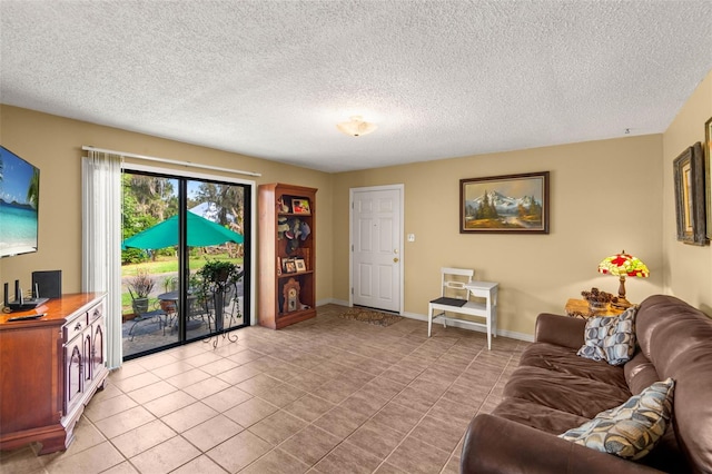 living room with a textured ceiling, light tile patterned flooring, and baseboards