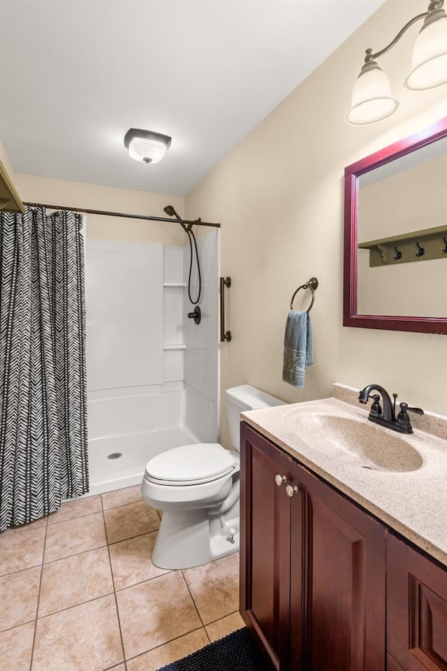 bathroom with a shower with curtain, tile patterned flooring, vanity, and toilet