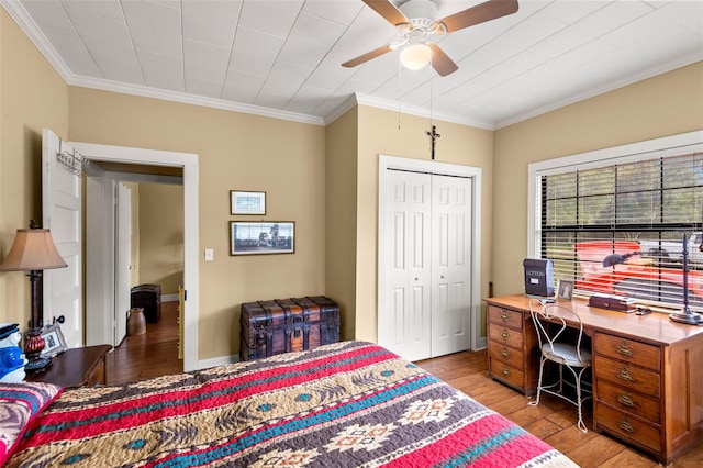 bedroom with ornamental molding, wood-type flooring, and a closet