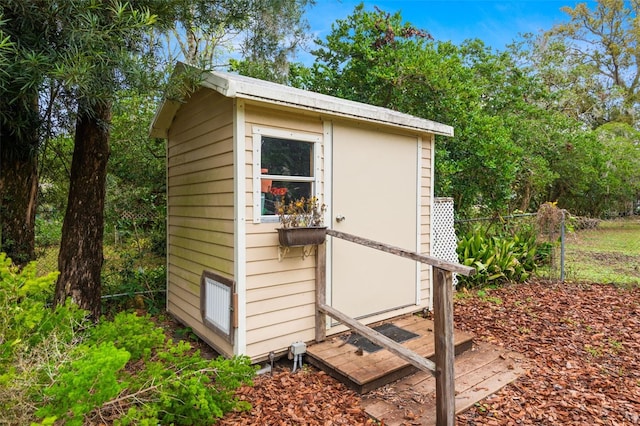 view of shed with fence