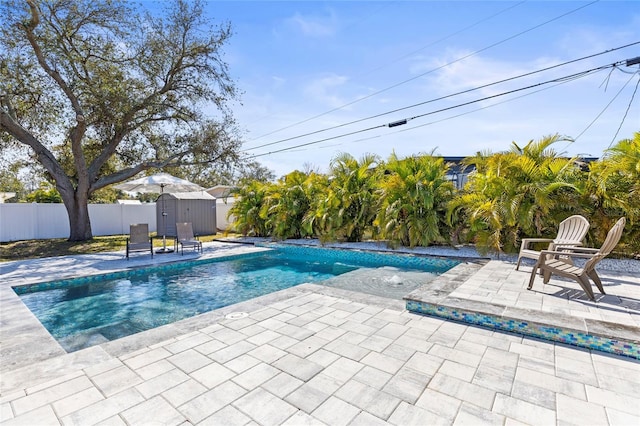 view of pool featuring a fenced in pool, a storage unit, a patio area, a fenced backyard, and an outdoor structure