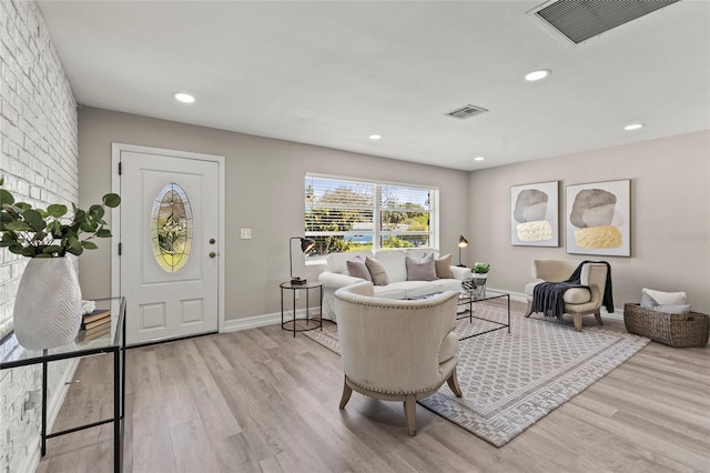 living room featuring baseboards, wood finished floors, visible vents, and recessed lighting