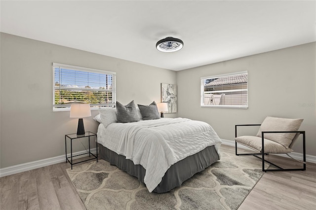 bedroom featuring baseboards and wood finished floors