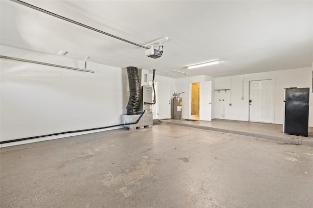 garage featuring freestanding refrigerator, a garage door opener, and electric water heater