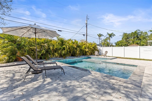 view of swimming pool with a patio, fence, and a fenced in pool