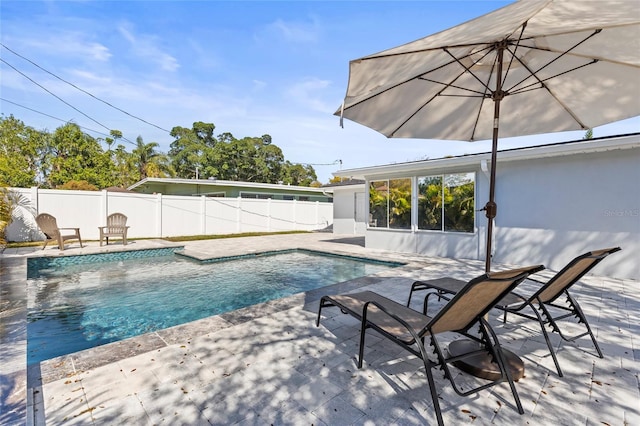 view of pool featuring fence, a fenced in pool, and a patio