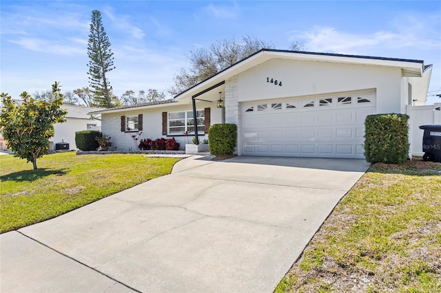 single story home featuring driveway, stucco siding, an attached garage, and a front yard