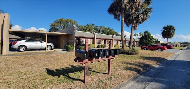 view of front of property featuring a front yard and a tiled roof